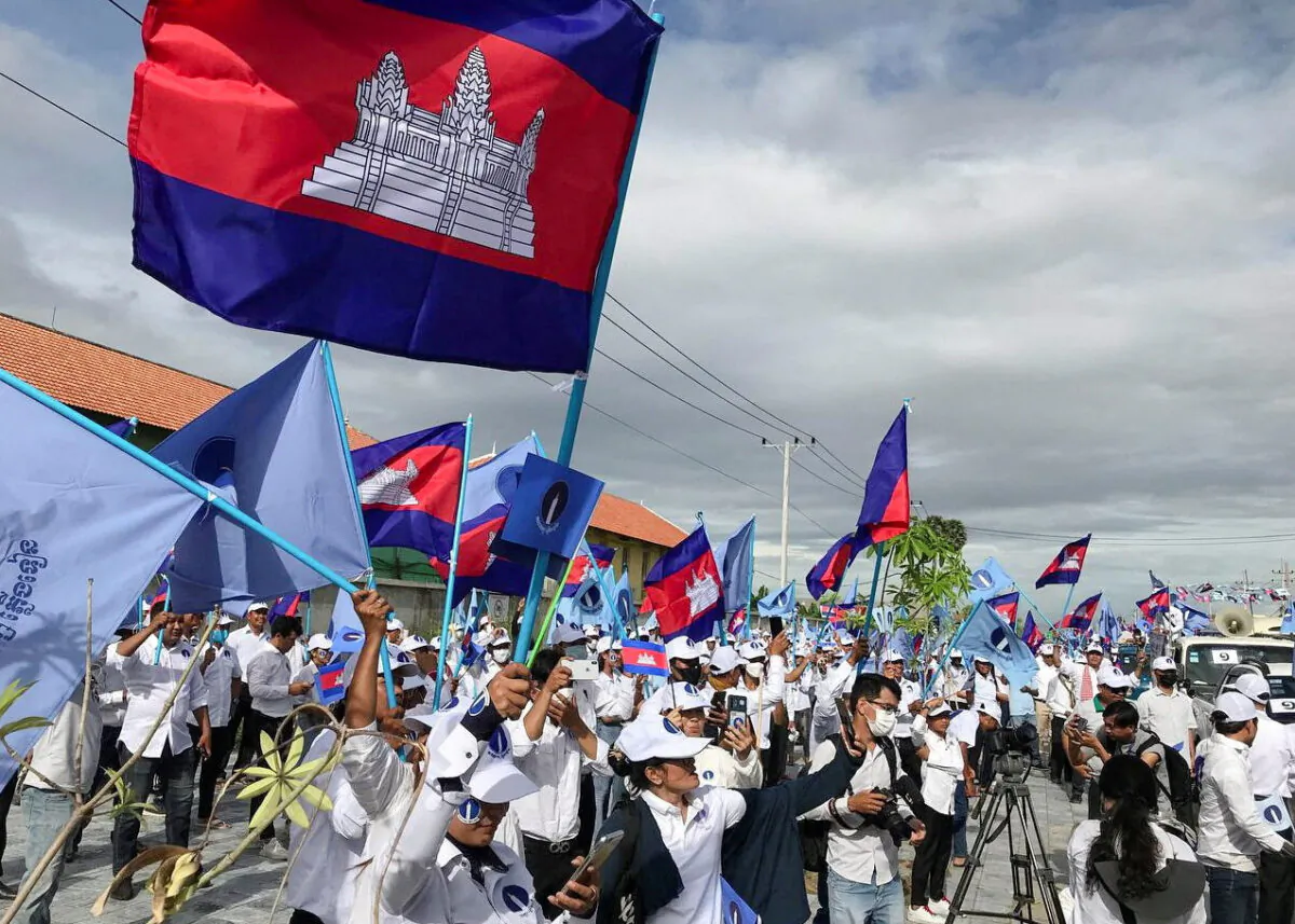 Supporters of the opposition party, Candlelight Party, wave flags as they take part in a campaign rally for the upcoming local elections on June 5, in Phnom Penh, Cambodia, on May 21, 2022. (Prak Chan Thul/Reuters)