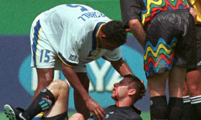 Miami Fusion's Tyrone Marshall (15) assists Kansas City Wizards' Scott Vermillion after the two collided while going up for a header in the first half of a soccer match in Kansas City, Mo., on Aug. 29, 1999. (Ed Zurga/AP Photo)