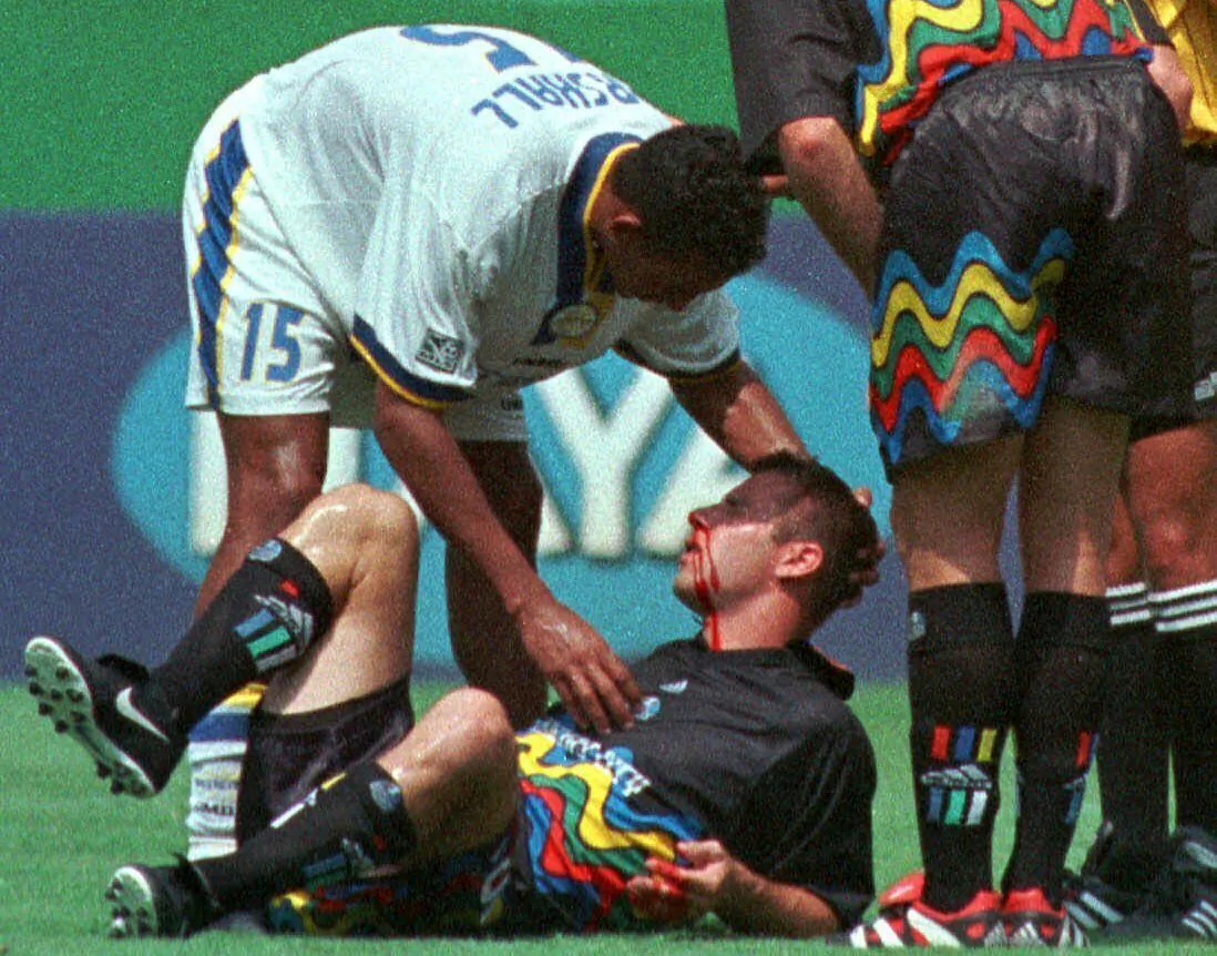 Miami Fusion's Tyrone Marshall (15) assists Kansas City Wizards' Scott Vermillion after the two collided while going up for a header in the first half of a soccer match in Kansas City, Mo., on Aug. 29, 1999. (Ed Zurga/AP Photo)
