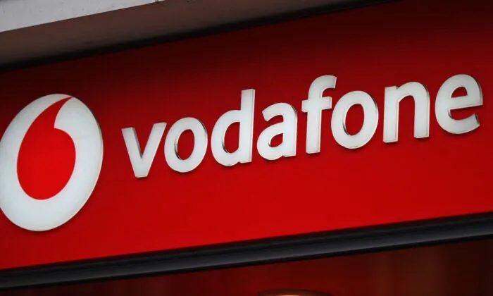 Branding for Vodafone is pictured outside a store in west London, England, on May 15, 2022. (Daniel Leal/AFP via Getty Images)