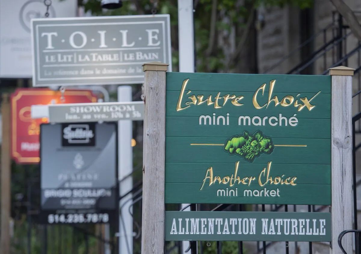A bilingual sign for a mini market is shown in the city of Westmount, on the Island of Montreal, Aug. 5, 2022. (The Canadian Press/Graham Hughes)
