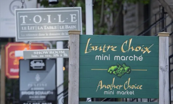 A bilingual sign for a mini market is shown in the city of Westmount, on the Island of Montreal, Aug. 5, 2022. (The Canadian Press/Graham Hughes)