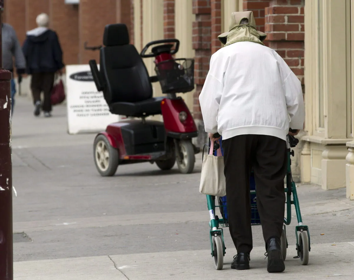A senior citizen walks down the main street in Peterborough, Ont., in a file photo. (The Canadian Press/Frank Gunn)