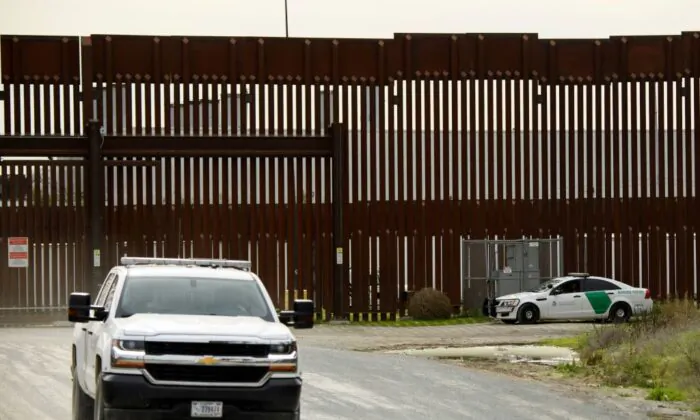 A US Border Patrol agents monitor from a vehicle a section of the US-Mexico border wall near Otay Mesa between San Diego and Tijuana in San Diego County, Calif., on Jan. 12, 2022. - When (Patrick T. Fallon/AFP via Getty Images)