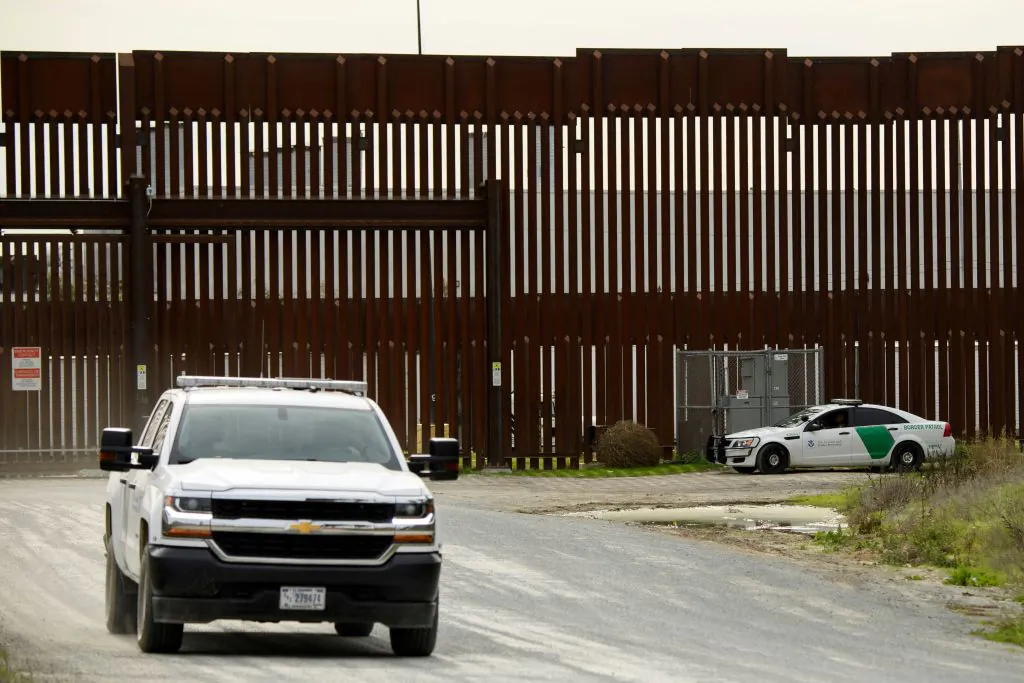 A U.S. Border Patrol agent monitors from a vehicle a section of the U.S.-Mexico border wall near Otay Mesa between San Diego and Tijuana in San Diego County, Calif., on Jan. 12, 2022. (Patrick T. Fallon/AFP via Getty Images)