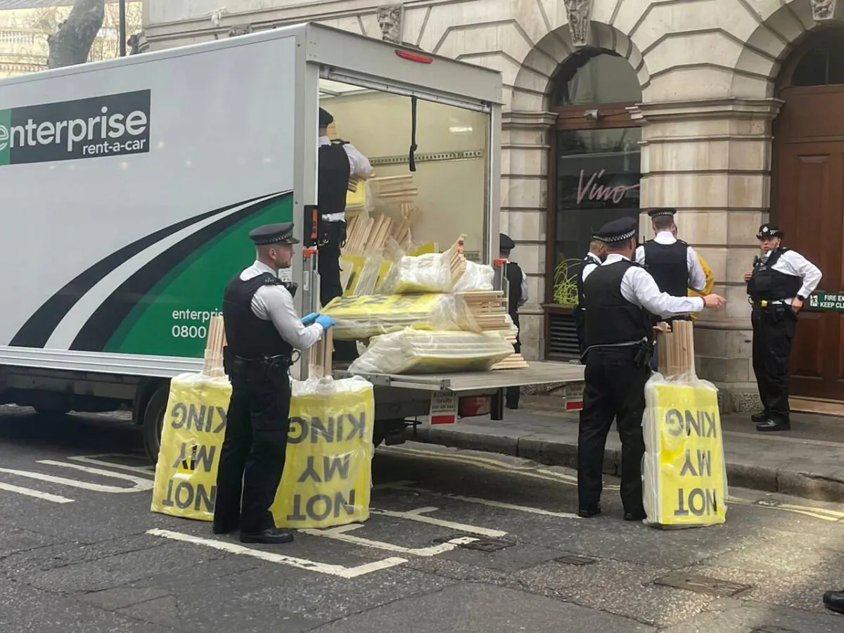 'Not My King' placards being removed by police officers after being confiscated from protesters during the coronation in central London on May 6, 2023. (Labour for a Republic/PA)