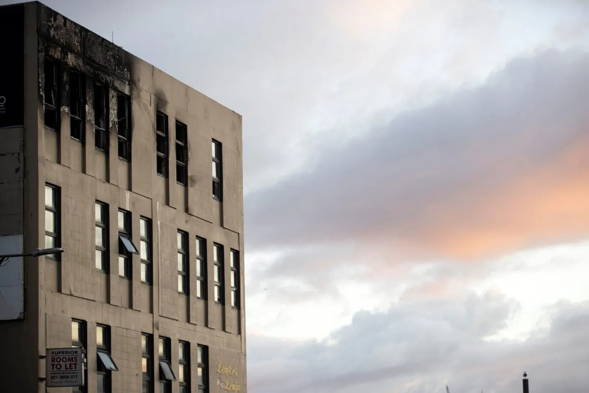 Morning light bathes the scene after an apartment fire at Loafers Lodge in Wellington, New Zealand, on May 17, 2023. (George Heard/New Zealand Herald via AP)