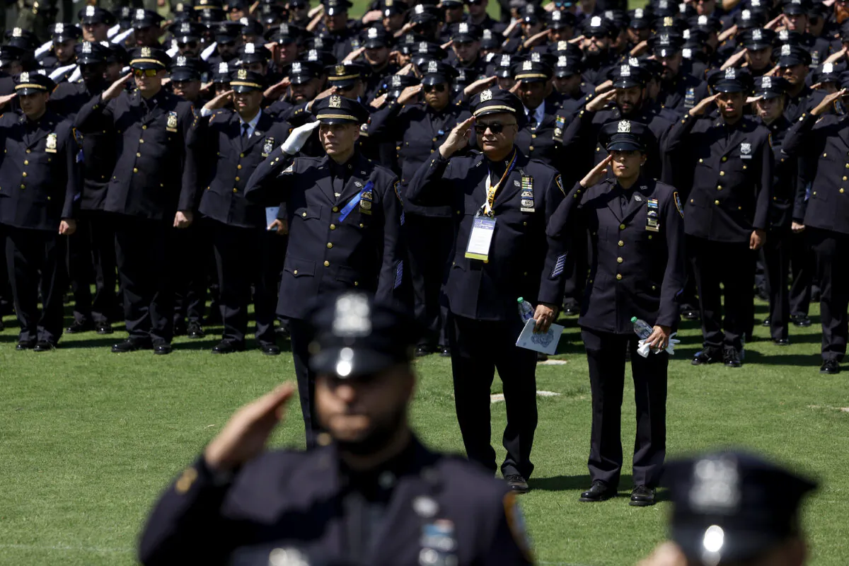 Police officers salute during the playing of the national anthem at the annual National Peace Officers' Memorial Service at the U.S. Capitol in Washington on May 15, 2023. (Anna Moneymaker/Getty Images)