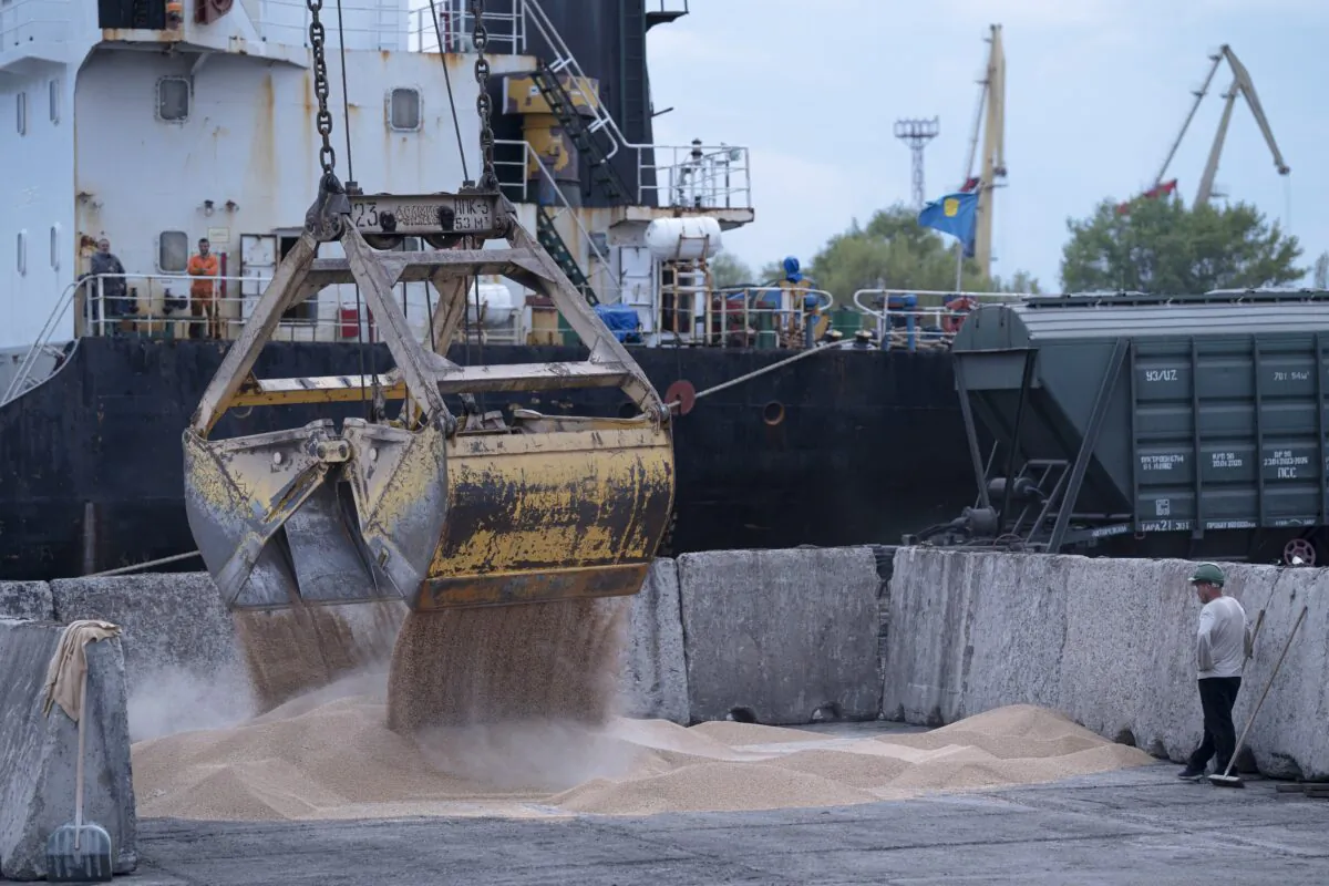 Workers load grain at a grain port in Izmail, Ukraine, on April 26, 2023. (Andrew Kravchenko/AP Photo)