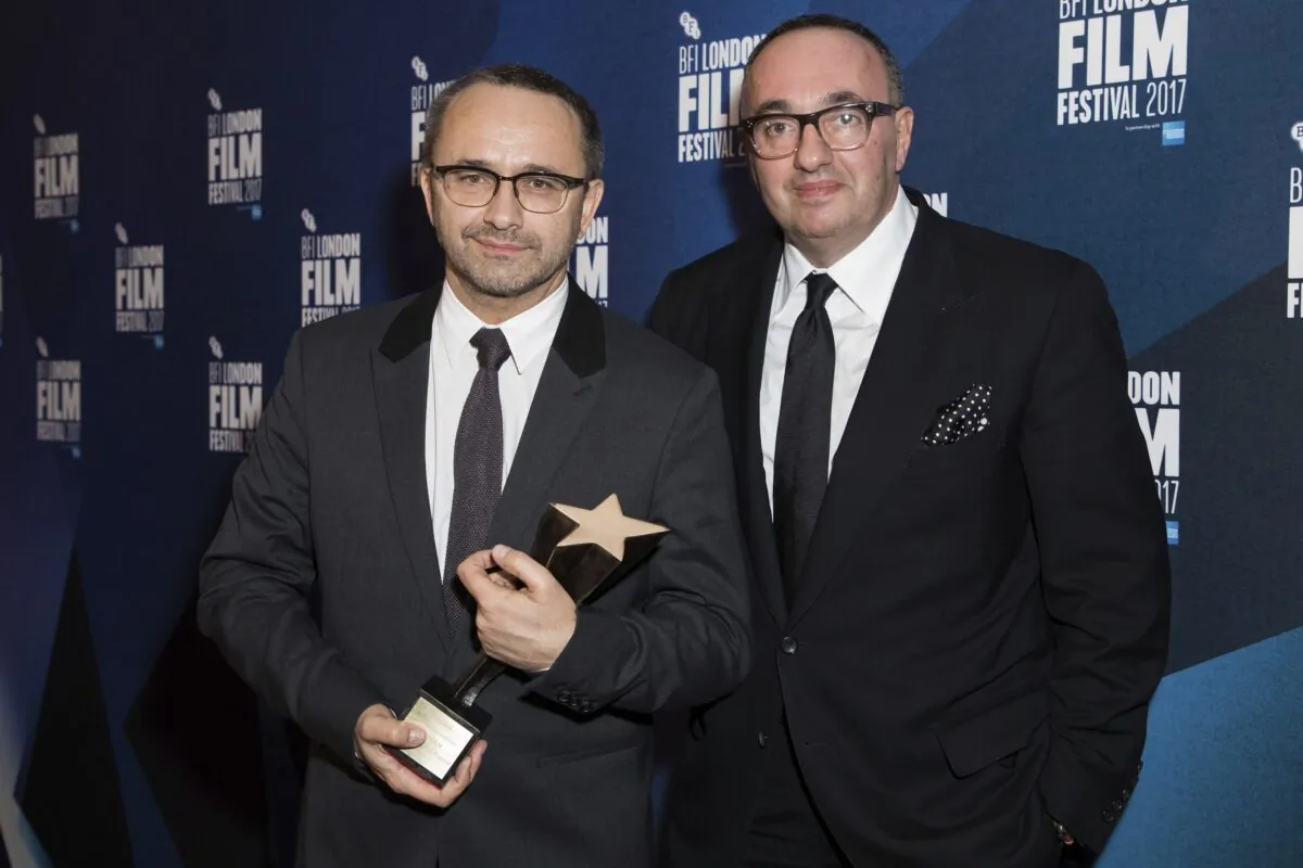Directors Andrey Zvyagintsev and Alexander Rodnyansky (R) pose for photographers after receiving the Official Competition Best Film award for their film 'Loveless' at the London Film Festival Awards in London on Oct. 14, 2017. (Vianney Le Caer/Invision/AP)