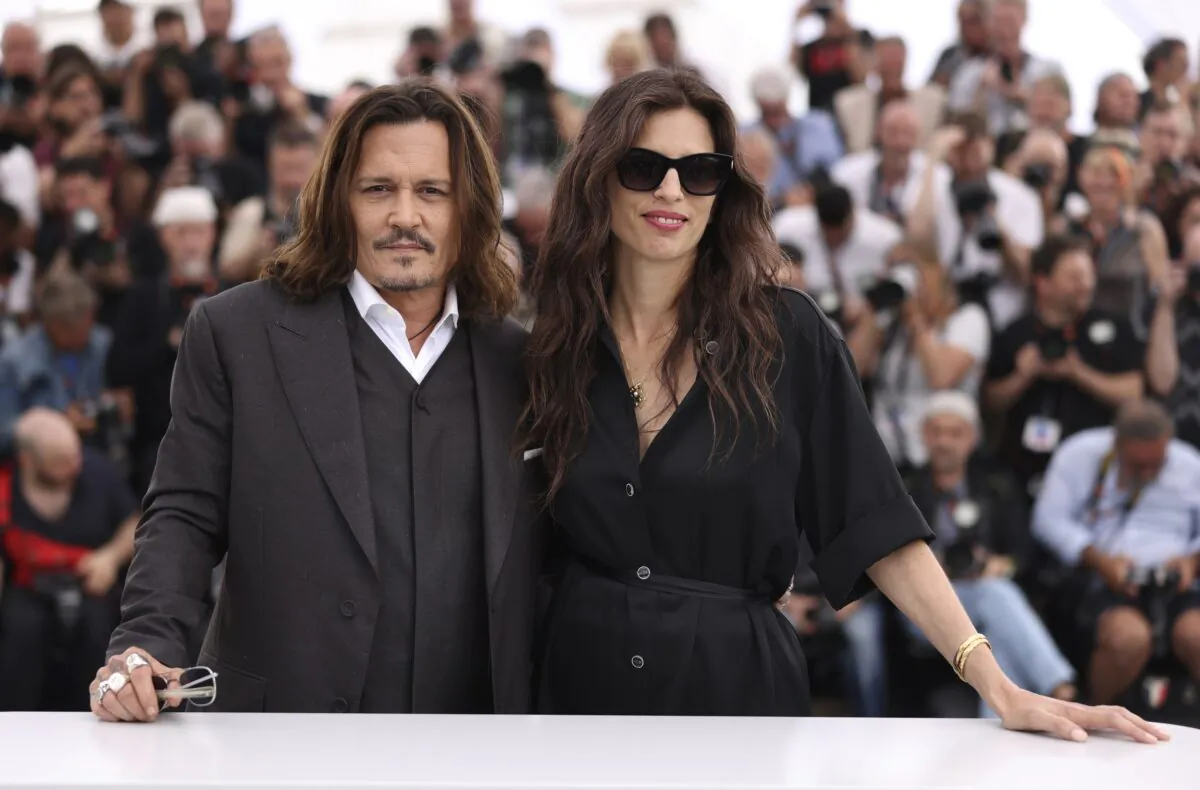 Johnny Depp (L) and director Maiwenn pose for photographers at the photo call for the film "Jeanne du Barry" at the 76th international film festival in Cannes, southern France, on May 17, 2023. (Vianney Le Caer/Invision/AP)
