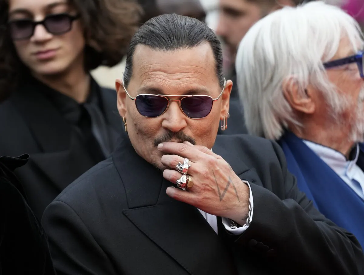 Johnny Depp poses for photographers upon arrival at the opening ceremony and the premiere of the film "Jeanne du Barry" at the 76th international film festival in Cannes, southern France, on May 16, 2023. (Scott Garfitt/Invision/AP)
