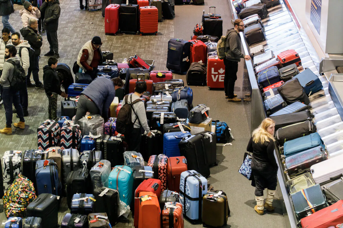 Luggage is amassed in the baggage claim area at Toronto Pearson International Airport, as a major winter storm disrupts flights in and out of the airport, on Dec. 24, 2022. (Cole Burston/The Canadian Press)