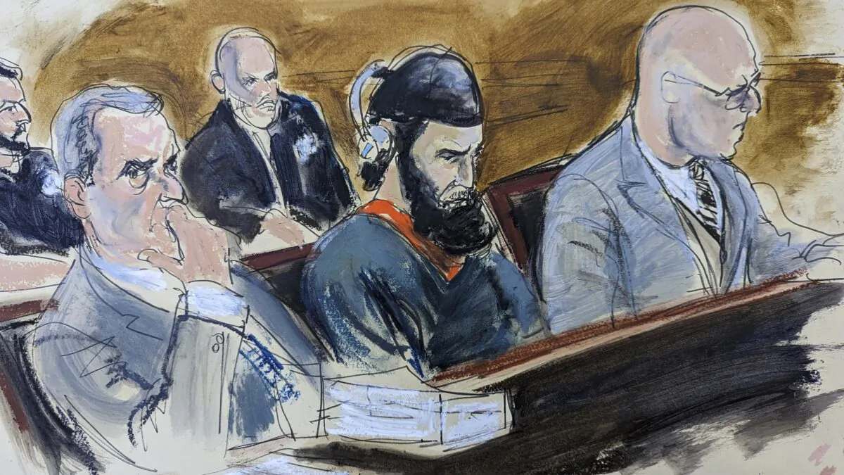 Sayfullo Saipov (C) is flanked by his attorneys David M. Stern (L) and federal Defender Andrew John Dalack (R) during victim impact statements in the sentencing phase of his trial in a courtroom sketch in federal court in New York on May 17, 2023. (Elizabeth Williams/AP Photo)
