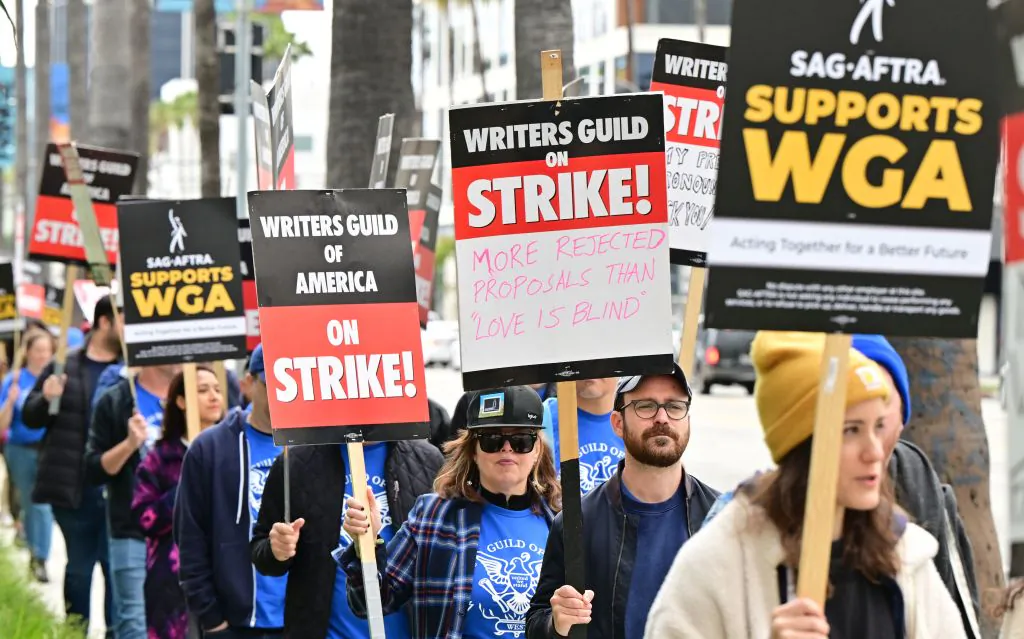 Writers on strike march with signs on the picket line on day four of the strike by the Writers Guild of America in front of Netflix in Hollywood, Calif., on May 5, 2023. (Frederic J. Brown/AFP via Getty Images)