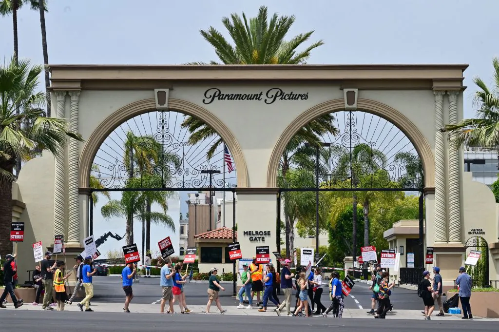 Writers hold signs while picketing in front of Paramount Studios in Los Angeles on May 15, 2023, as the strike by the Writers Guild of America enters its third week. (Frederic J. Brown/AFP via Getty Images)