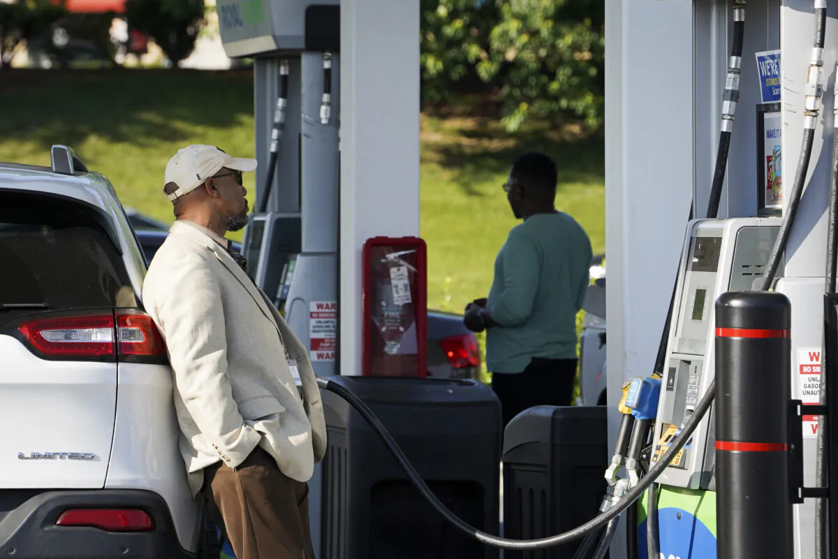 People use a gas station in Columbia, Md., on May 17, 2023. (Madalina Vasiliu/The Epoch Times)