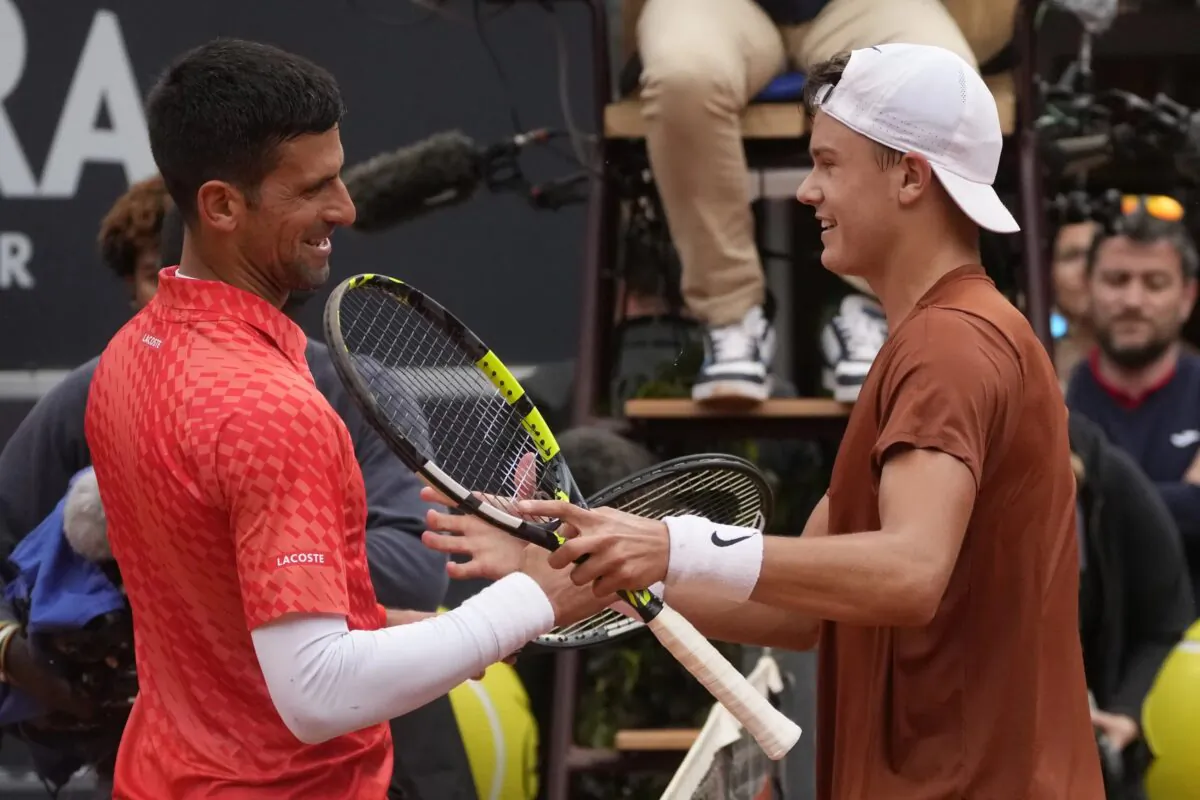 Denmark's Holger Rune (R) celebrates after winning the quarterfinal match against Serbia's Novak Djokovic at the Italian Open tennis tournament in Rome on May 17, 2023. (Gregorio Borgia/AP Photo)