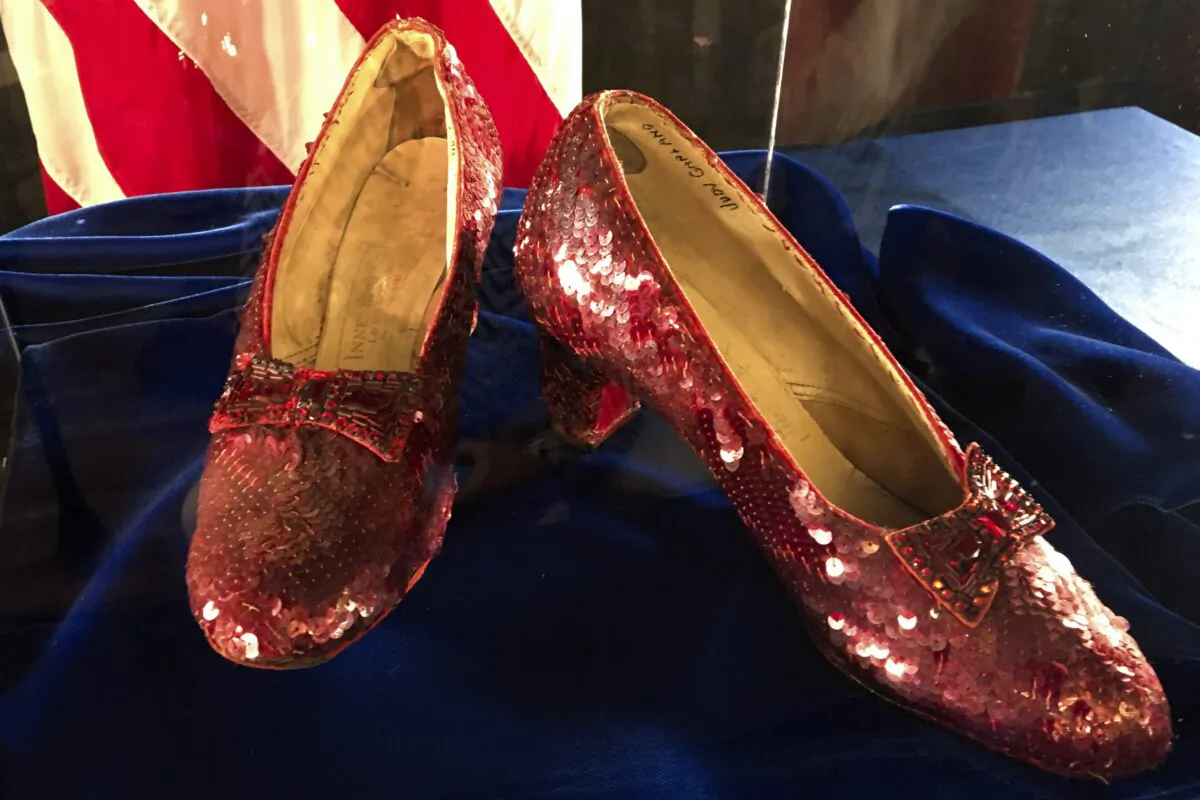 A pair of ruby slippers once worn by actress Judy Garland in the "The Wizard of Oz" sit on display at a news conference at the FBI office in Brooklyn Center, Minn., on Sept. 4, 2018. (Jeff Baenen/AP Photo)
