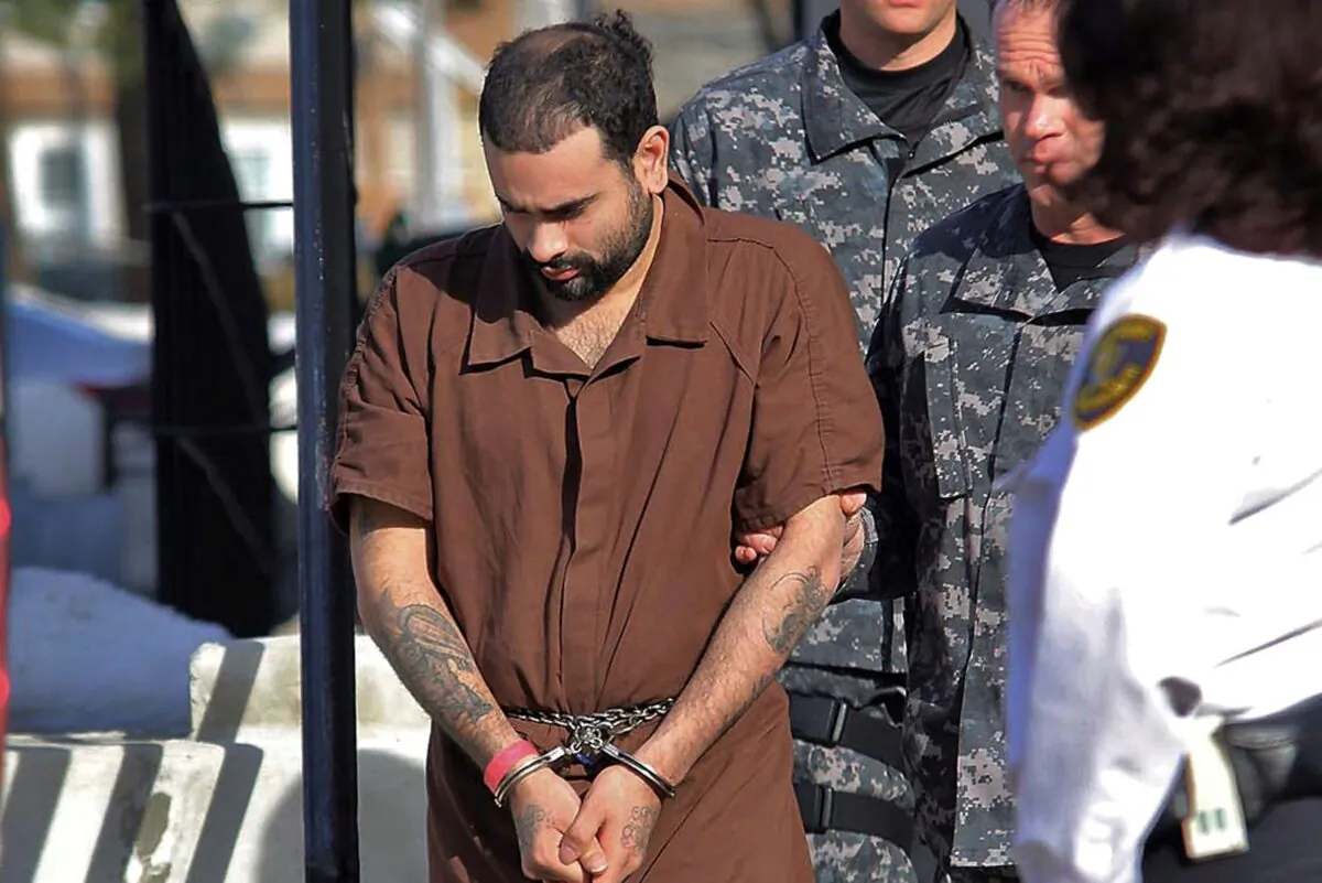 Alberto Sierra is escorted from Fitchburg District Court following a hearing in Fitchburg, Mass., on Dec. 24, 2013. (John Love/The Sentinel & Enterprise via AP)