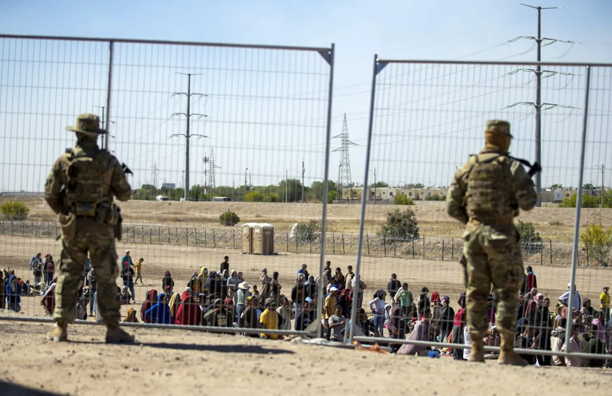 Texas National Guard troops watch over illegal immigrants in El Paso, Texas, on May 10, 2023. (Andres Leighton/AP Photo)