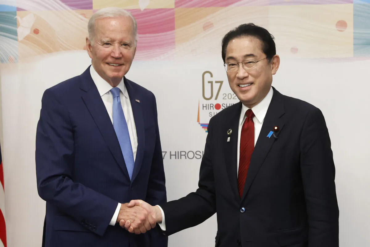 U.S. President Joe Biden (L) and Japanese Prime Minister Fumio Kishida shake hands prior to a bilateral meeting ahead of the Group of Seven leaders summit in Hiroshima, Japan, on May 18, 2023. (Kiyoshi Ota/Getty Images)