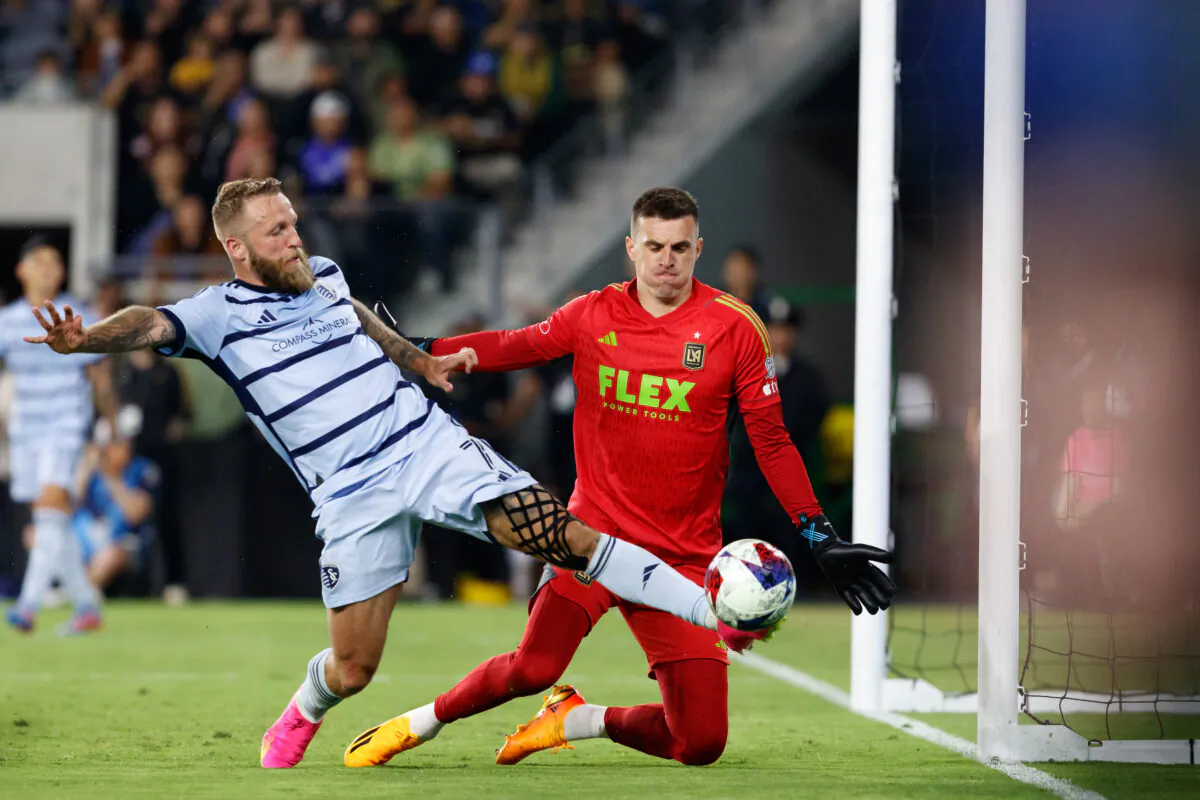 LAFC goalkeeper Eldin Jakupovic (1) defends against Sporting Kansas City forward Johnny Russell (7) at BMO Stadium in Los Angeles on May 17, 2023. (Courtesy of LAFC)