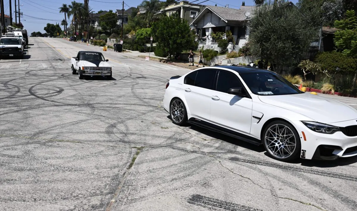 Vehicles drive over tire skid marks from other drivers doing burnouts and "donuts" in the Angelino Heights neighborhood of Los Angeles on Aug. 26, 2022. (Patrick T. Fallon/AFP via Getty Images)