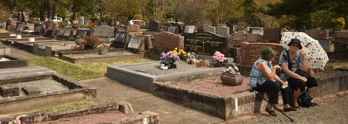 This photo taken on September 24, 2017 shows visitors sitting amongst the gravestones to commemorate the 150-year anniversary of Rockwood -- the largest cemetery in the southern hemisphere -- in Sydney.( PETER PARKS/AFP via Getty Images)