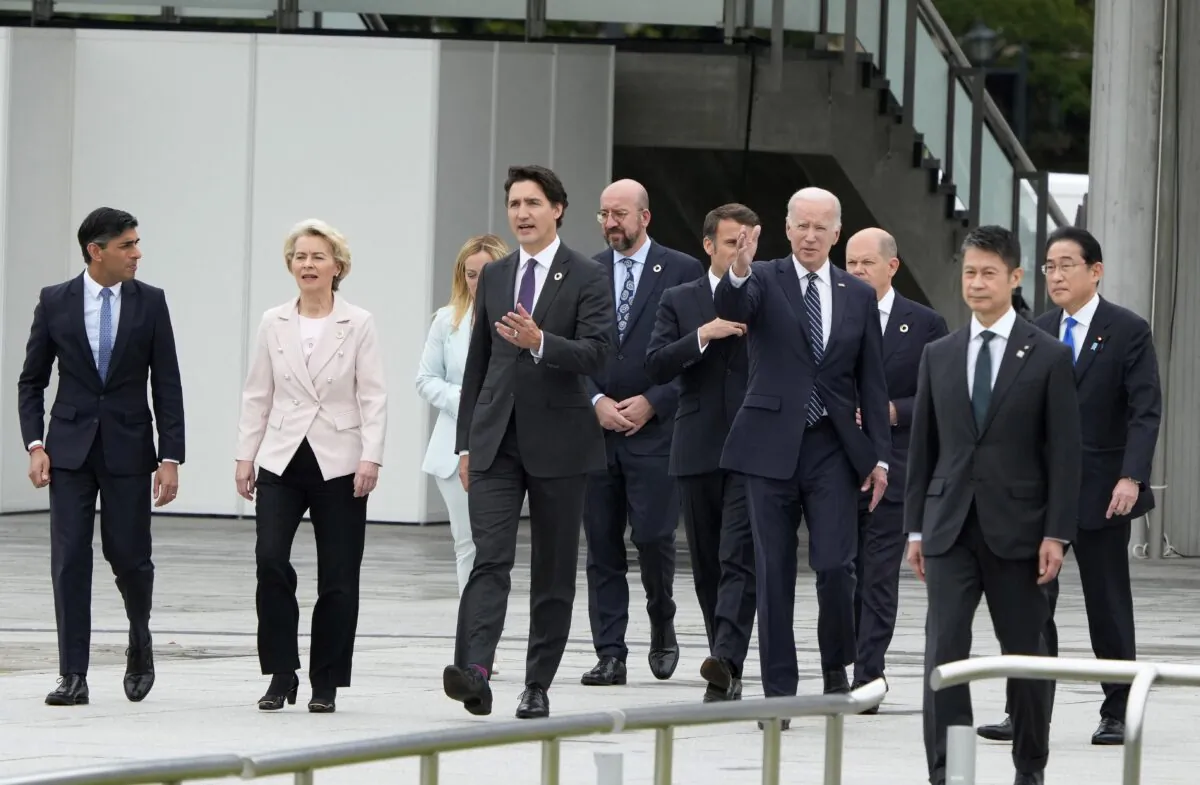 (L-R) British Prime Minister Rishi Sunak, European Commission President Ursula von der Leyen, Italian Prime Minister Giorgia Meloni, Canadian Prime Minister Justin Trudeau, European Council President Charles Michel, French President Emmanuel Macron, U.S. President Joe Biden, German Chancellor Olaf Scholz, and Japan's Prime Minister Fumio Kishida walk out of the Peace Memorial Museum to a flower wreath-laying ceremony in the Peace Memorial Park as part of the G-7 Leaders' Summit, in Hiroshima, Japan, on May 19, 2023. (Franck Robichon/POOL/AFP via Getty Images)
