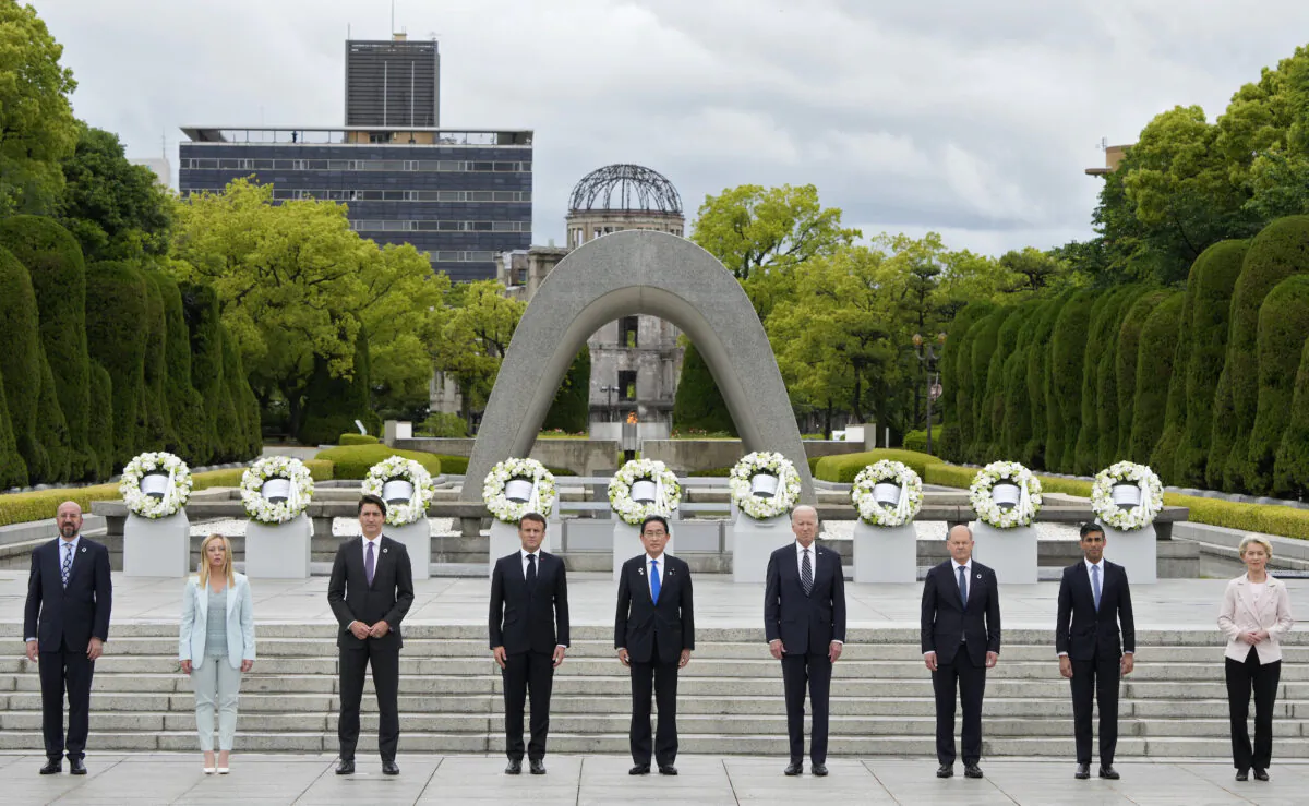 European Council President Charles Michel, Italian Prime Minister Giorgia Meloni, Canadian Prime Minister Justin Trudeau, French President Emmanuel Macron, Japanese Prime Minister Fumio Kishida, U.S. President Joe Biden, German Chancellor Olaf Scholz, British Prime Minister Rishi Sunak, and European Commission President Ursula von der Leyen pose for a group photo after laying flower wreaths at the Cenotaph for Atomic Bomb Victims in the Peace Memorial Park on the sidelines of the G-7 summit  in Hiroshima, Japan, on May 18, 2023. (Franck Robichon/Pool/Getty Images)