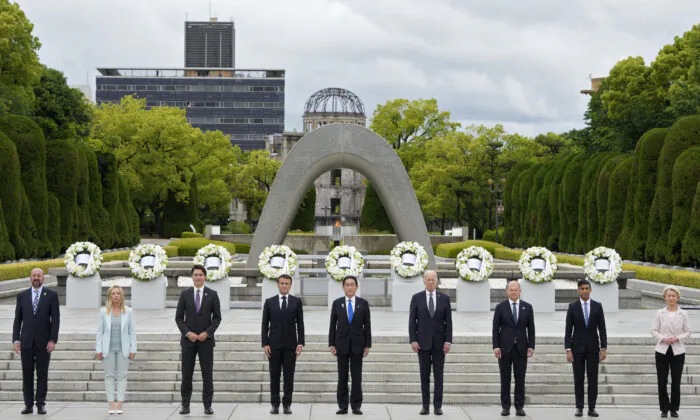 European Council President Charles Michel, Italian Prime Minister Giorgia Meloni, Canadian Prime Minister Justin Trudeau, French President Emmanuel Macron, Japanese Prime Minister Fumio Kishida, U.S. President Joe Biden, German Chancellor Olaf Scholz, British Prime Minister Rishi Sunak, and European Commission President Ursula von der Leyen pose for a group photo after laying flower wreaths at the Cenotaph for Atomic Bomb Victims in the Peace Memorial Park on the sidelines of the G-7 summit  in Hiroshima, Japan, on May 18, 2023. (Franck Robichon/Pool/Getty Images)