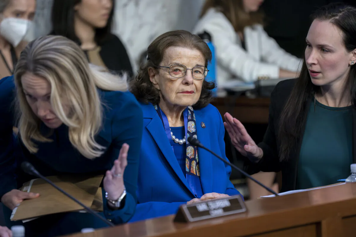 Sen. Dianne Feinstein is flanked by aides as she returns to the Senate Judiciary Committee at the Capitol following a more than two-month absence as she was being treated for a case of shingles on May 11, 2023. (J. Scott Applewhite/AP Photo)