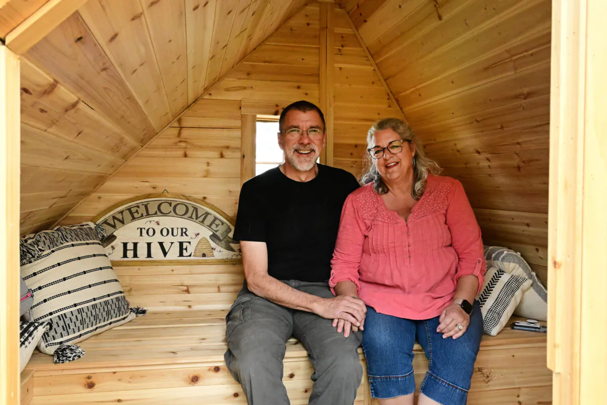 Charlie Peterson and his wife, Carolyn, owners of Capella Ranch in Lafayette, Colorado, sit together inside one of their two new "Bee Huts" on May 2, 2023. At this small ranch, about five miles northeast of Boulder, the Petersons have a barnyard full of animals on their five acre property, including goats, sheep, ducks, chickens, and even turkeys. They keep eight beehives inside two handmade huts. The pair have created a new experience with their "Bee Huts," where visitors can relax just inches from the bees without getting stung. (Helen H. Richardson/The Denver Post/TNS)