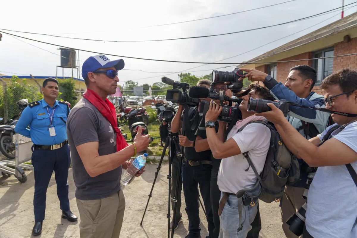 British mountaineer Kenton Cool, who successfully completed his 17th summit of Mount Everest, speaks with the media upon arrival at the airport in Kathmandu, Nepal, on May 19, 2023. (Niranjan Shrestha/AP Photo)