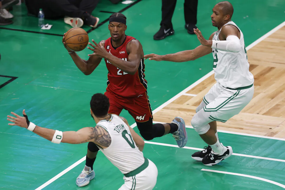 Miami Heat forward Jimmy Butler, top left, looks to pass between Boston Celtics forward Jayson Tatum, bottom left, and center Al Horford, right, during the second half of Game 2 of the NBA basketball playoffs Eastern Conference finals in Boston on May 19, 2023. (Michael Dwyer/AP Photo)
