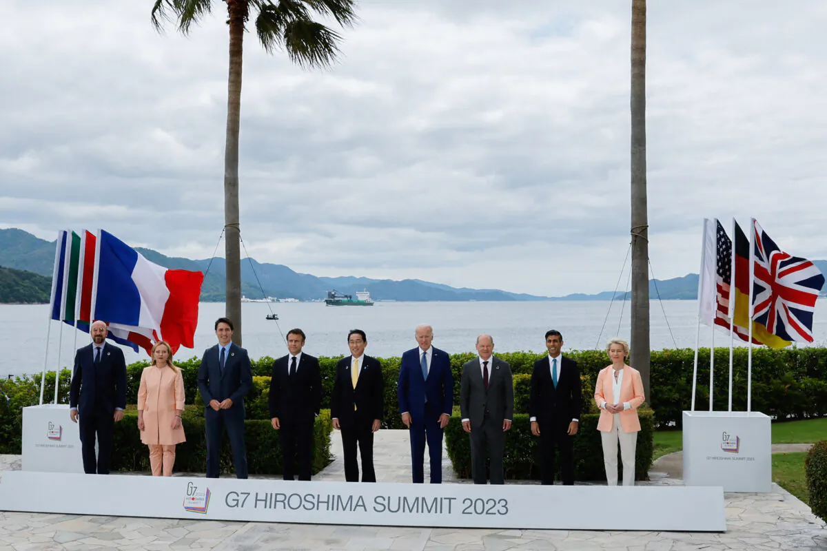 (L–R) European Council President Charles Michel, Italian Prime Minister Giorgia Meloni, Canadian Prime Minister Justin Trudeau, French President Emmanuel Macron, Japanese Prime Minister Fumio Kishida, U.S. President Joe Biden, German Chancellor Olaf Scholz, British Prime Minister Rishi Sunak, and European Commission President Ursula von der Leyen participate in a photo with G-7 leaders before their working lunch meeting on economic security at the Grand Prince Hotel in Hiroshima, Japan, on May 20, 2023. (Jonathan Ernst/Pool/AFP via Getty Images)