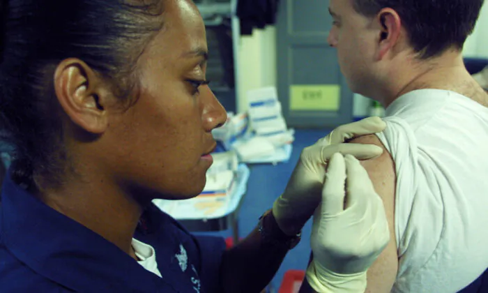 A U.S. military member receives a smallpox vaccine in the Gulf of Aden off the coast of Djibouti in a 2003 file image. (Sean Gallup/Getty Images)