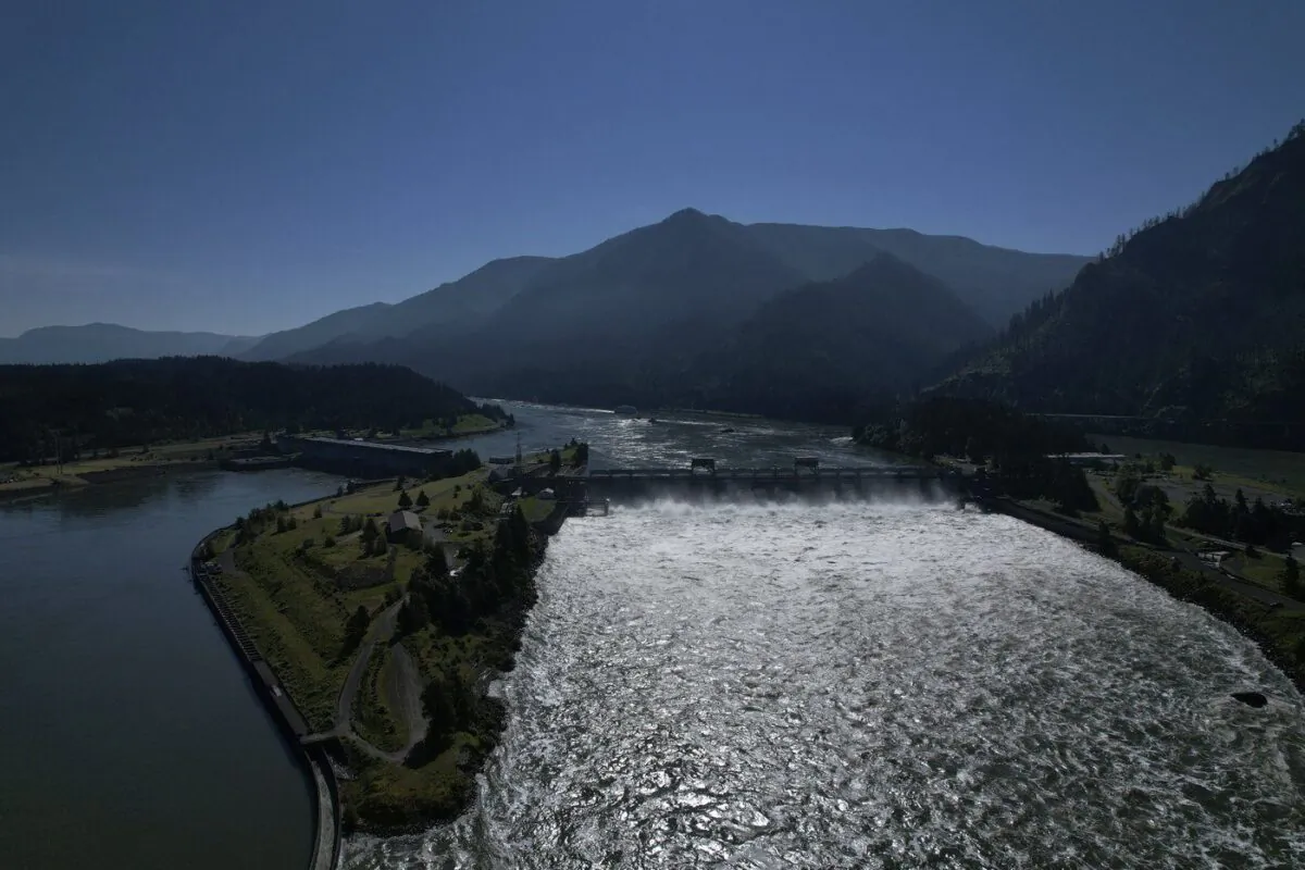 Water spills over the Bonneville Dam on the Columbia River, which runs along the Washington and Oregon state line, on June 21, 2022. (The Canadian Press/AP-Jessie Wardarski)