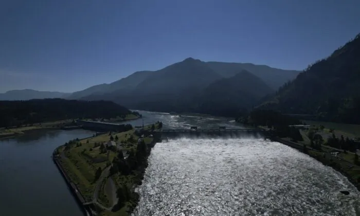 Water spills over the Bonneville Dam on the Columbia River, which runs along the Washington and Oregon state line, on June 21, 2022. (The Canadian Press/AP-Jessie Wardarski)
