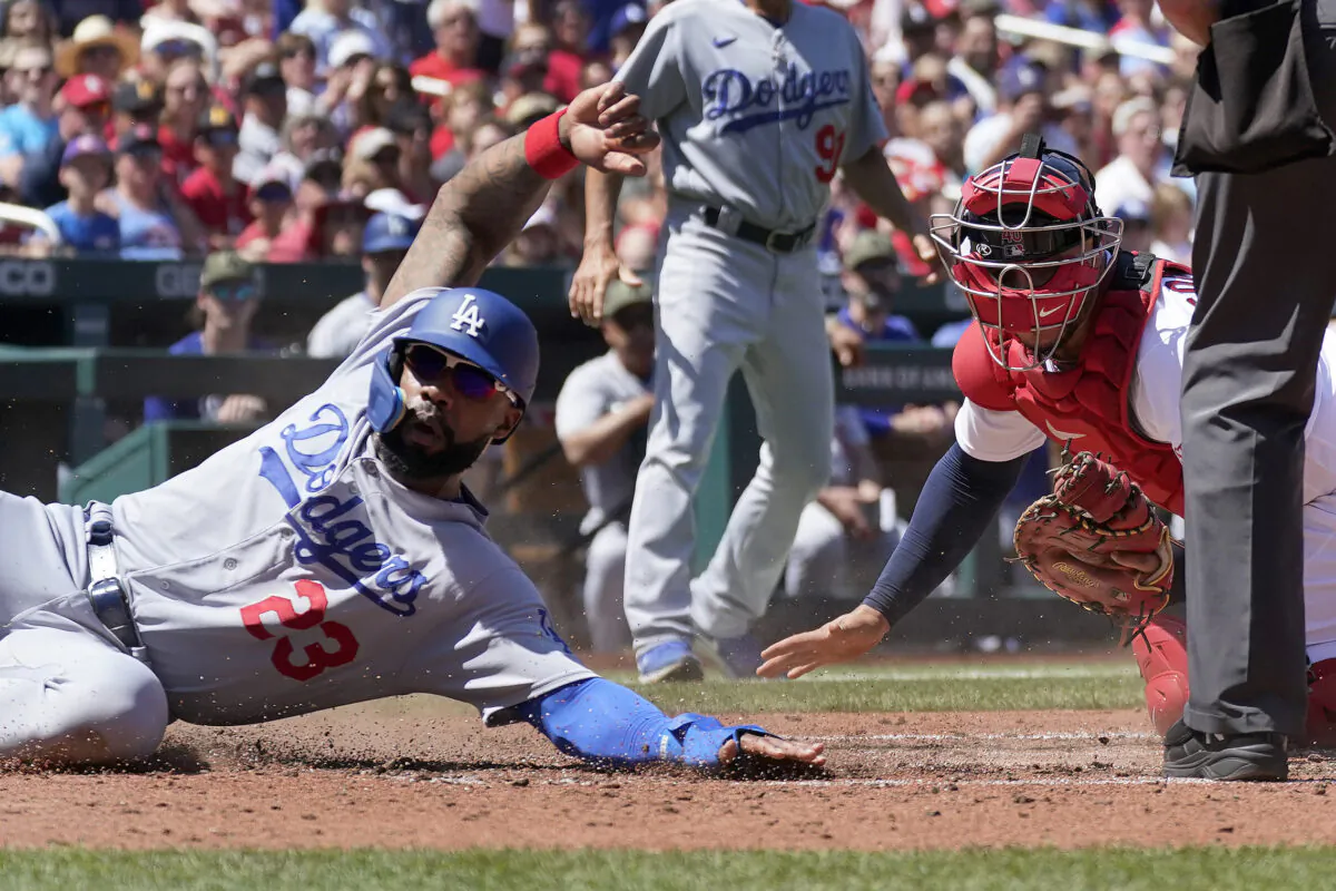 Los Angeles Dodgers' Jason Heyward (23) avoids the tag from St. Louis Cardinals catcher Willson Contreras, right, to score during the fifth inning of a baseball game in St. Louis on May 21, 2023. (Jeff Roberson/AP Photo)