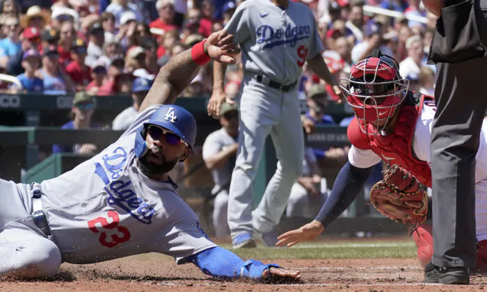 Los Angeles Dodgers' Jason Heyward (23) avoids the tag from St. Louis Cardinals catcher Willson Contreras, right, to score during the fifth inning of a baseball game in St. Louis on May 21, 2023. (Jeff Roberson/AP Photo)