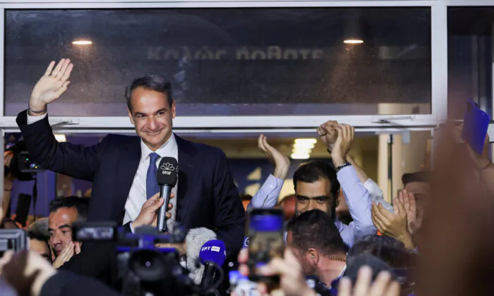 Greek Prime Minister and New Democracy conservative party leader Kyriakos Mitsotakis waves outside the party's headquarters, after the general election, in Athens, Greece, on May 21, 2023. (Louiza Vradi/Reuters)