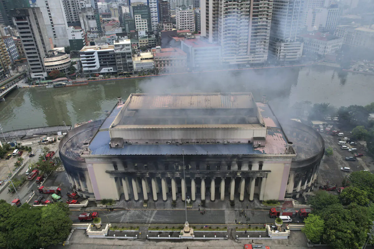 Smoke billows from the still smoldering Manila Central Post Office in Manila, Philippines, on May 22, 2023. (AP Photo/Aaron Favila)