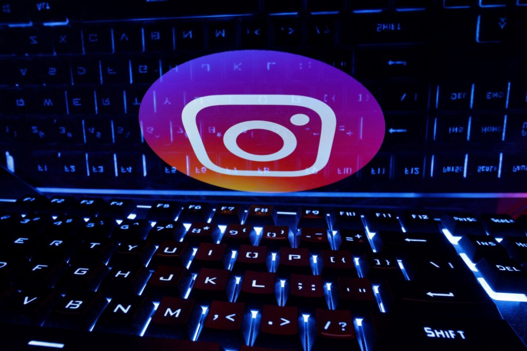 A keyboard in front of a displayed Instagram logo in an illustration taken on Feb. 21, 2023. (Dado Ruvic/Illustration/Reuters)