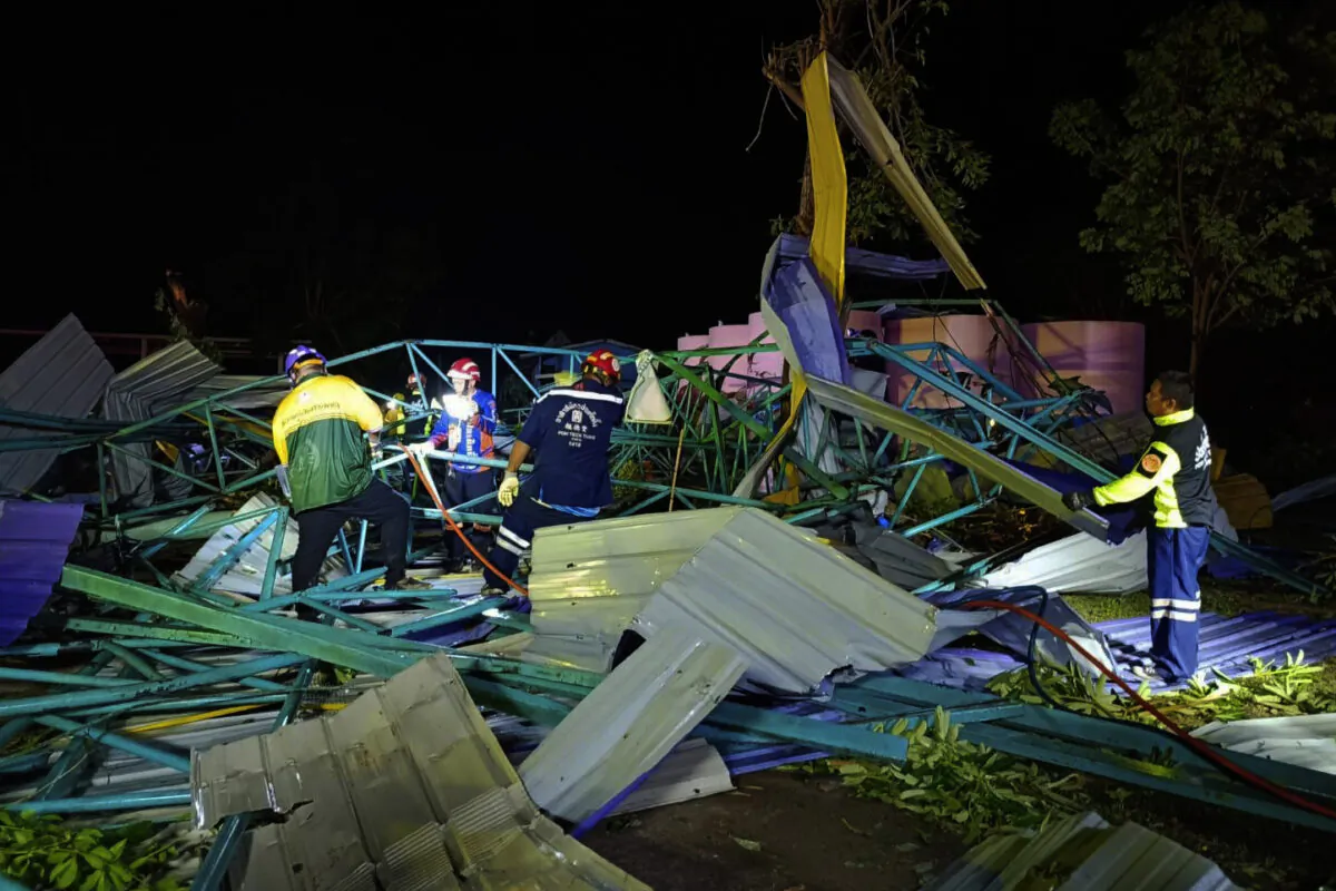 Thai rescue workers at the scene of a collapsed metal roof on a structure at the Wat Nern Por primary school in Phichit province in northern Thailand on May 22, 2023. (Phichit Province's Public Relations Department via AP)