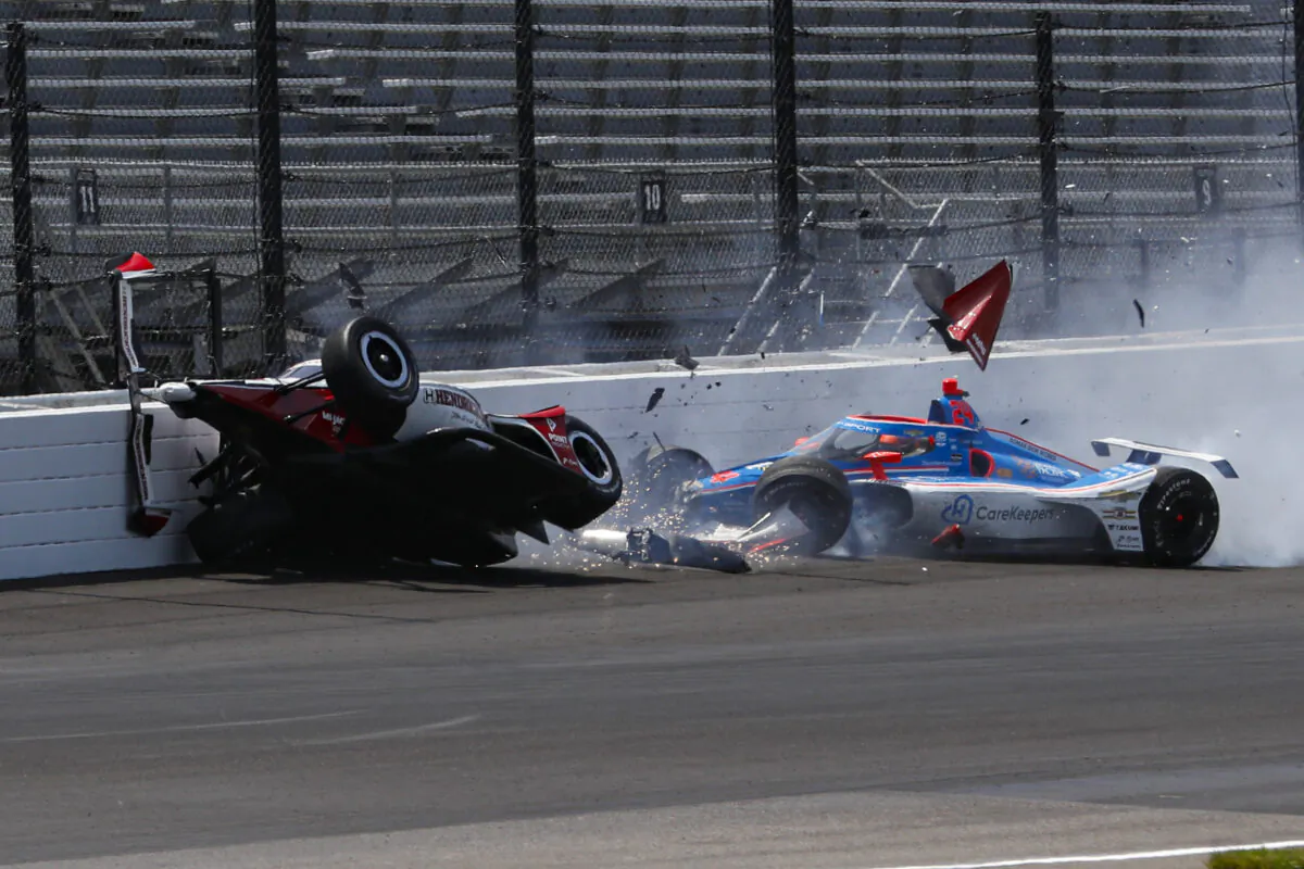 Katherine Legge of England (L) and Stefan Wilson of England crash in the first turn during practice for the Indianapolis 500 auto race at Indianapolis Motor Speedway in Indianapolis on May 23, 2023. (Kirk DeBrunner/AP Photo)