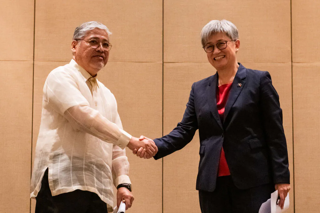 Philippine Foreign Affairs Secretary Enrique Manalo and Australian Foreign Minister Penny Wong shake hands during a joint press conference, at a hotel in Makati, Metro Manila, Philippines, on May 18, 2023. (Lisa Marie David - Pool/Getty Images)