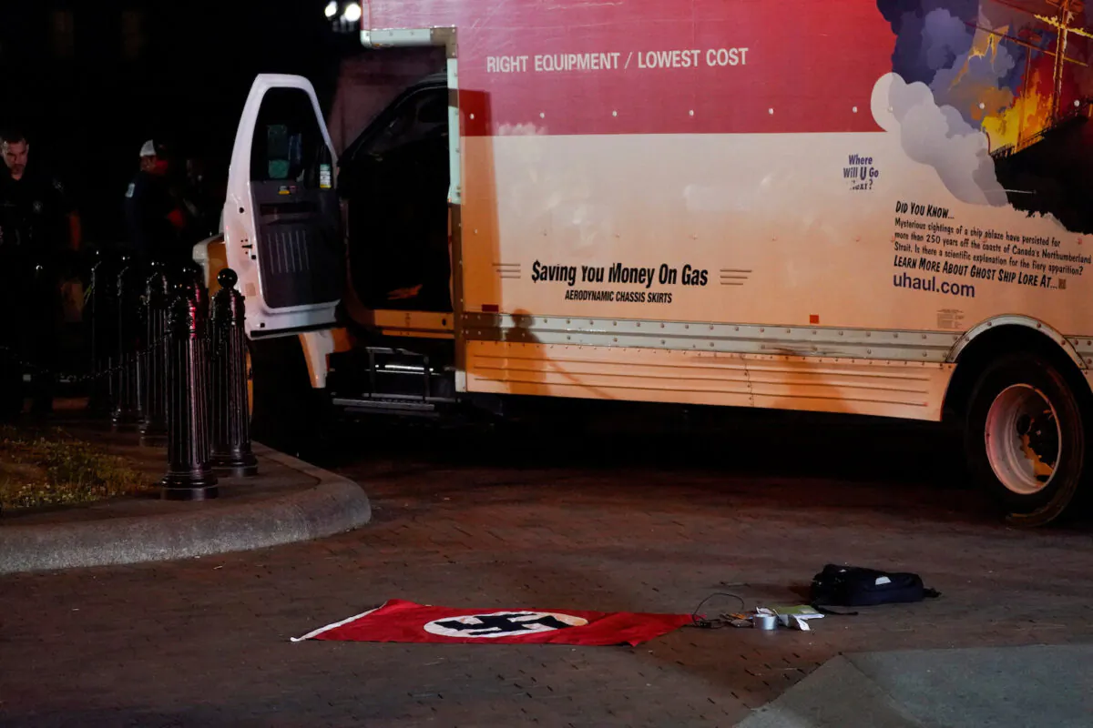 A Nazi-style flag and other objects recovered from a rented box truck are pictured on the ground as the U.S. Secret Service and other law enforcement agencies investigate the truck that crashed into security barriers at Lafayette Park across from the White House in Washington on May 23, 2023. (Nathan Howard/Reuters)