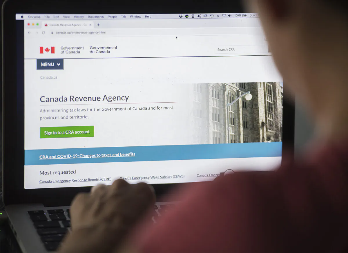 A person looks at a Canada Revenue Agency homepage in Montreal, on Aug. 16, 2020. (The Canadian Press/Graham Hughes)